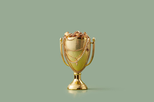 Champion bowl filled with treasures on khaki background