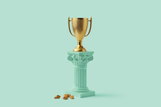 Golden goblet standing on turquoise column in studio