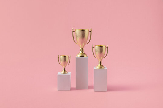Three different podiums with shiny goblets on tops