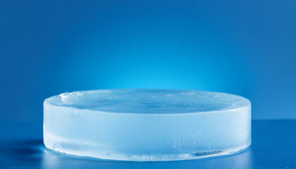Round ice pedestal for product presentation on blue background. Pedestal in studio. Cool display.