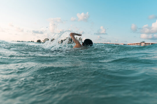 Boy swims freestyle in salt water