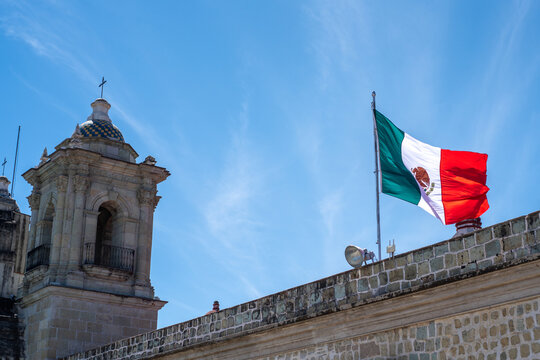 Oaxaca church wall with Mexican flag
