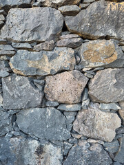 Volcanic rocks folded into a stone wall. Cloct up.
