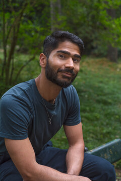 Relaxed camera aware portrait with kind Indian man