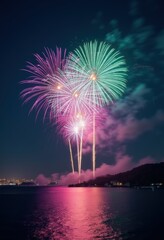 Fototapeta premium Vibrant fireworks illuminate the night sky over calm waters, creating a mesmerizing display perfect for celebrations and events.