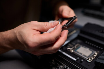 Hands Engaged in the Process of Working on Computer Hardware Installation and Upgrading