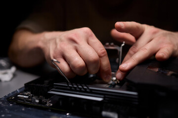 Hands Engaged in the Process of Working on Computer Hardware Installation and Upgrading