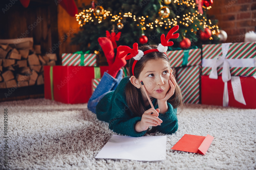 Poster Full size photo of little girl lying floor minded write letter dressed green christmas outfit day light home party decoration interior room