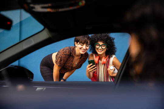 Shared Laughter Before Getting in a Ride 