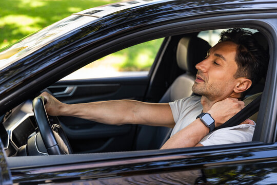 A Driver Stretches in Car
