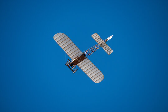 Bleriot XI vintage airplane flying in blue sky. Radio Controlled airplane