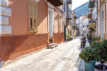 Wander through the picturesque streets of Nafplio, where pastel-colored buildings line cobblestone paths, inviting exploration and discovery in this historical Greek town.