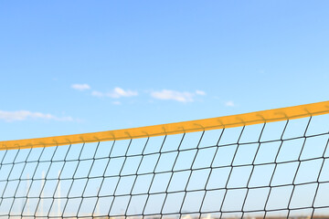 Beach volleyball net close-up. Fragment of a volleyball net on the beach against the blue sky....