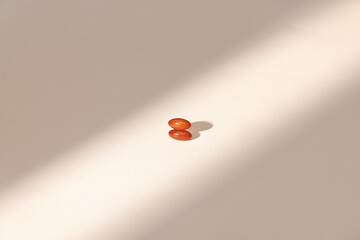 Two Capsules Bathed in Streak of Natural Light 