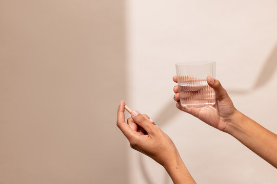 Taking Medicine With Water in a Calm Indoor Setting