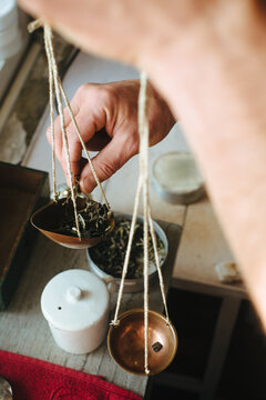 Weighing Tea Using Vintage Scales for Tasting at a Tea Factory