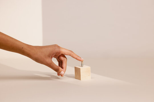 Hand Balancing Pill on Wooden Block