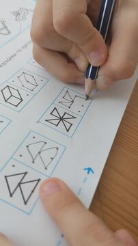 Kid child drawing shapes, learning to write, fingers close up.  Early education, preschool, home schooling, primary school learning. Dysgraphia. Learn handwriting. Montessori