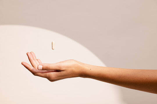 Hand Reaching for a Nutritional Supplement