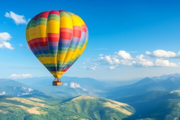 Obraz premium Colorful Hot Air Balloon Soaring Over Scenic Mountain Landscape