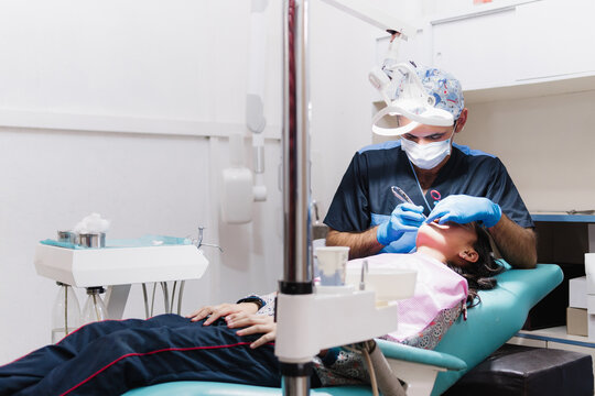 Odontologist placing brackets.