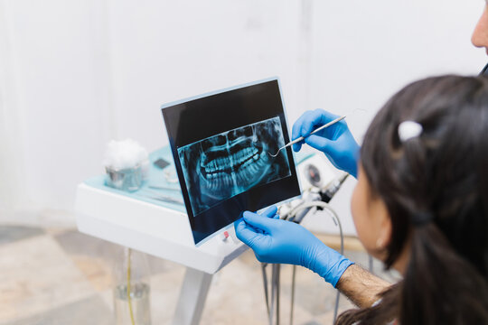 Dentist analyzing an X-ray in his office.