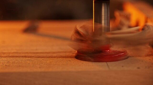 Close up of carpenter's hand, joiner working in workshop.Making wooden furniture. Handcraft.Carpentry, craft.Using CNC machine, cutting shapes from wooden boards in joinery workshop.Slow motion.