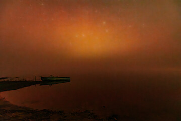 A peaceful scene of boats resting on a calm, misty shoreline under a glowing orange sky. The tranquil water and faint stars create a serene and atmospheric mood.