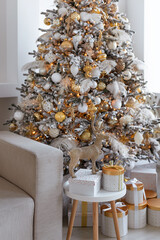 An Elegant Christmas Tree beautifully positioned in a Modern Living Room, adorned with Gifts