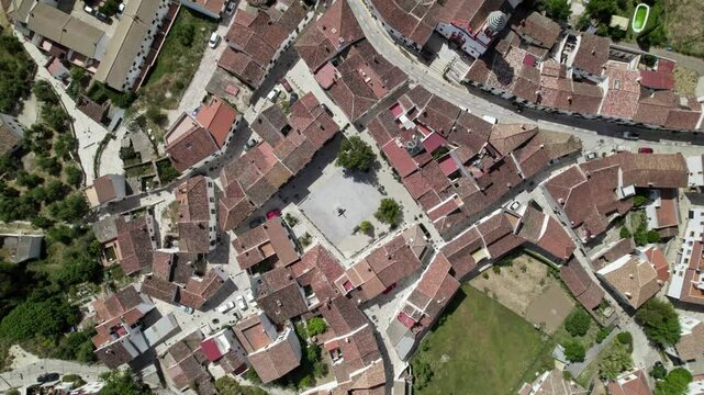 Aerial view of a Mediterranean village with central plaza, historic houses, and narrow streets, Atajate, Malaga, Andalucia, Spain