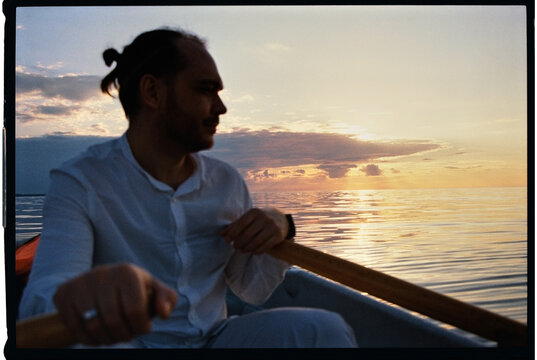 Man Rowing Boat at Sunset