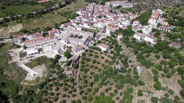 Aerial View of Quaint Village Nestled in Scenic Mountainous Terrain, Surrounded by Lush Greenery, Atajate, Malaga, Andalucia, Spain