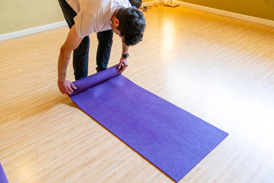 Preparing for yoga class unrolling