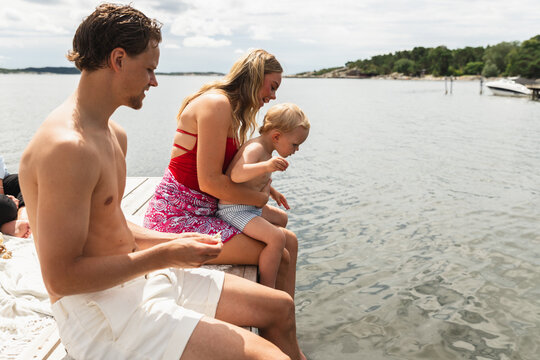 Parents and Young Son Enjoying Time Together on Jetty