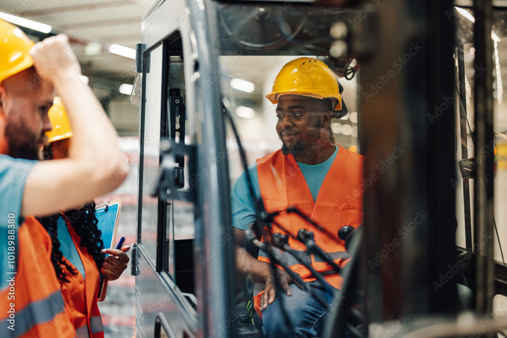 Wall mural warehouse workers talking to forklift driver in warehouse