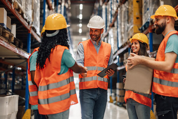 Warehouse workers shaking hands after a successful deal