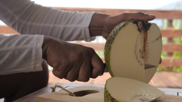 Man cutting breadfruit (Martinique)