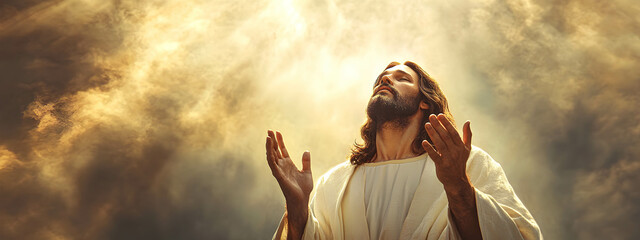 Jesus prays with hands raised to heaven, radiating peace and holiness, against the sky, a replica of space. Concept Religion.