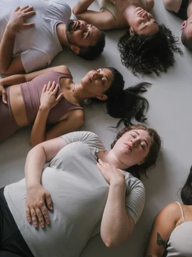 Group Yoga Meditation With Eyes Closed on Floor
