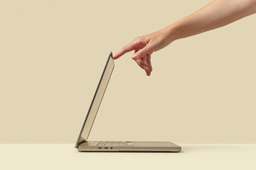 Silver laptop getting activated by owner while standing in studio