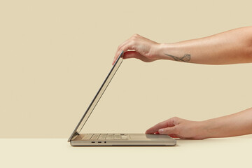 Human holding top and bottom of laptop while adjusting screen angle