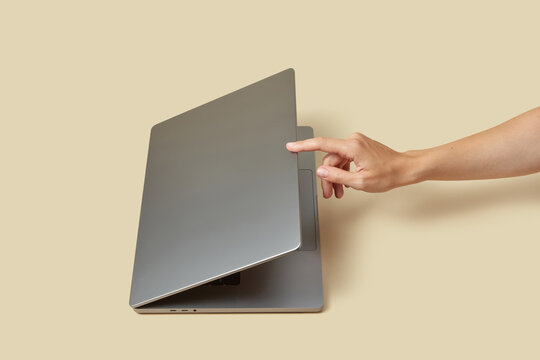 Caucasian person pressing on display of pc with index finger