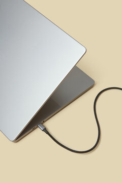 Black cable plugged in port of computer for internet transmission