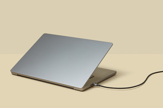 USB flash drive connected to grey laptop in studio