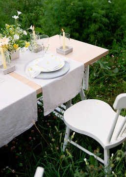 Empty dinner table in field