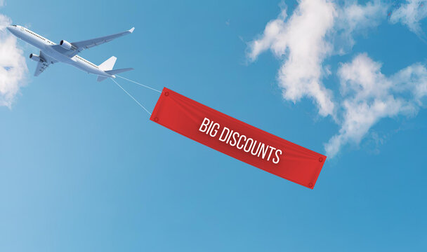 plane flying in clear blue sky is pulling banner that reads BIG DISCOUNTS, creating exciting atmosphere for potential shoppers.  promotion sale advertising banner