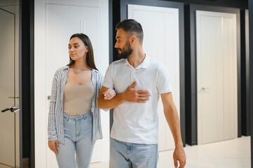 Fototapeta premium A married couple chooses new interior doors for their home at a hardware store