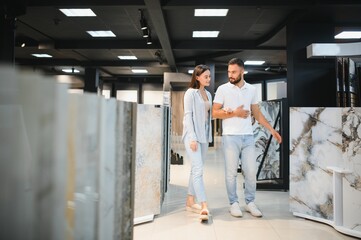 Young married couple chooses tiles for their home together