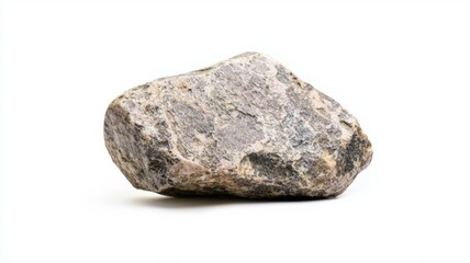 A rough textured rock resting on a white surface under bright lighting in a minimalist setting