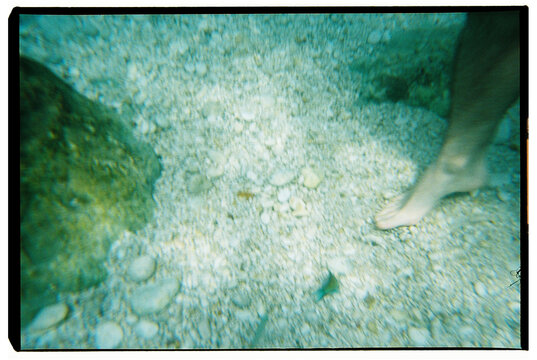 Feet Underwater on Rocky Bed